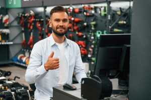 Cashier is at work. Man is in the hardware shop.